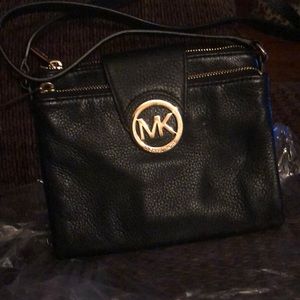 Michael Kors black leather cross body pocketbook.